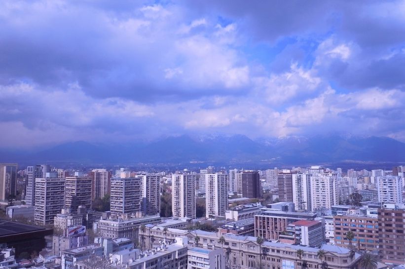Todo lo que necesitas saber para arrendar un departamento en Santiago. Imagen de edificios en Santiago de Chile, con cordillera de los Andes al fondo.